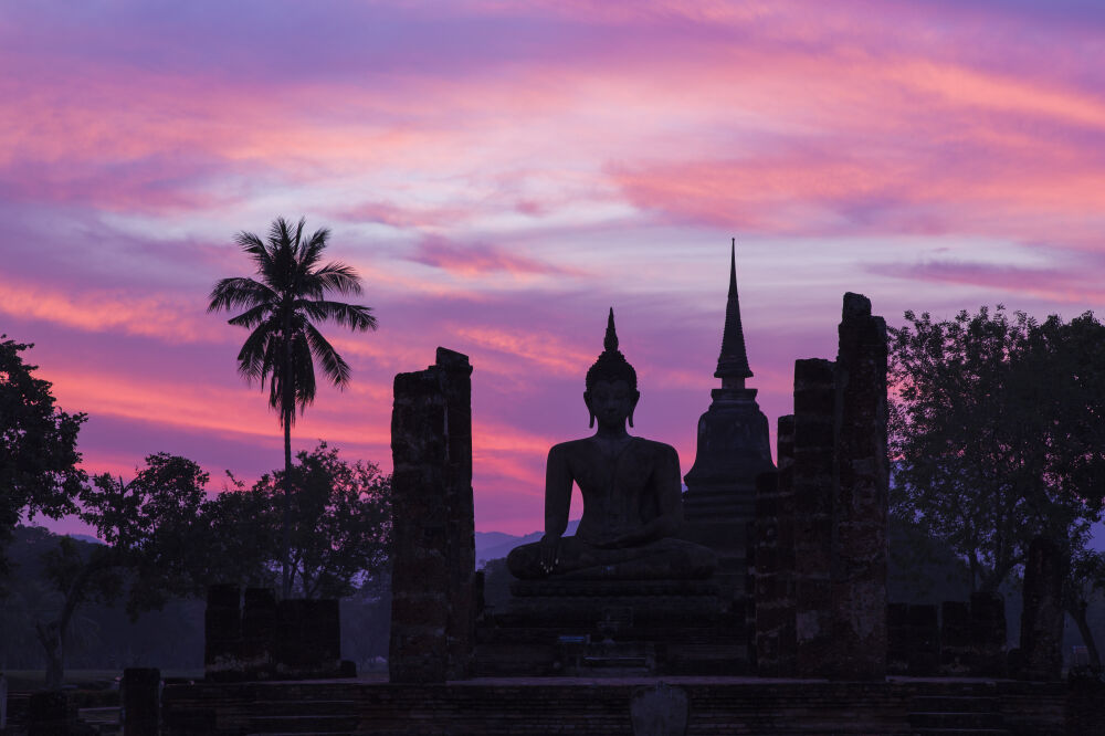 Boeddha beeld bij zonsondergang in Sukhothai, Thailand