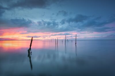 Colorful sunset over calm water with reflections