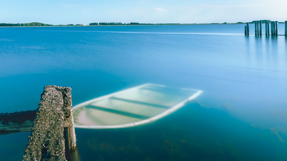 Sunken boat in old ferry port in the province of Zeeland in the Netherlands