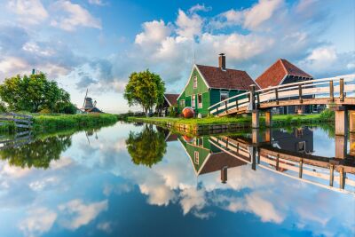 Authentic Dutch landscape in Zaanse Schans with water reflections and traditional houses