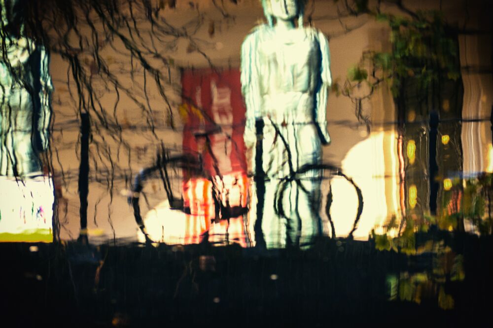 Reflections of a bicycle in the Oudegracht in Utrecht