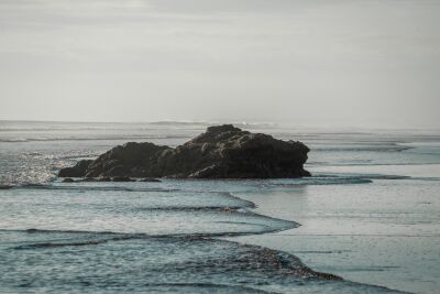 Rustic Coastal Rock Solitary in the Surf