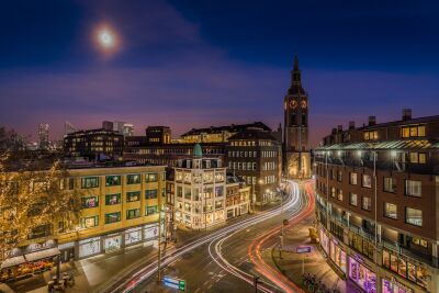 Night photograph of The Hague's Grote Kerk (The Hague Tower) with city light trails