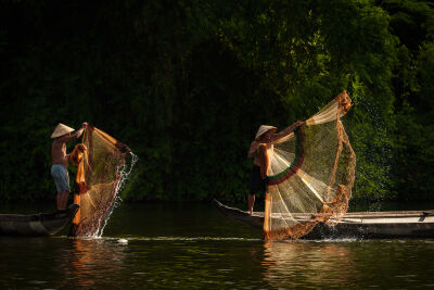 Fisherman on the river in Hue, Vietnam
