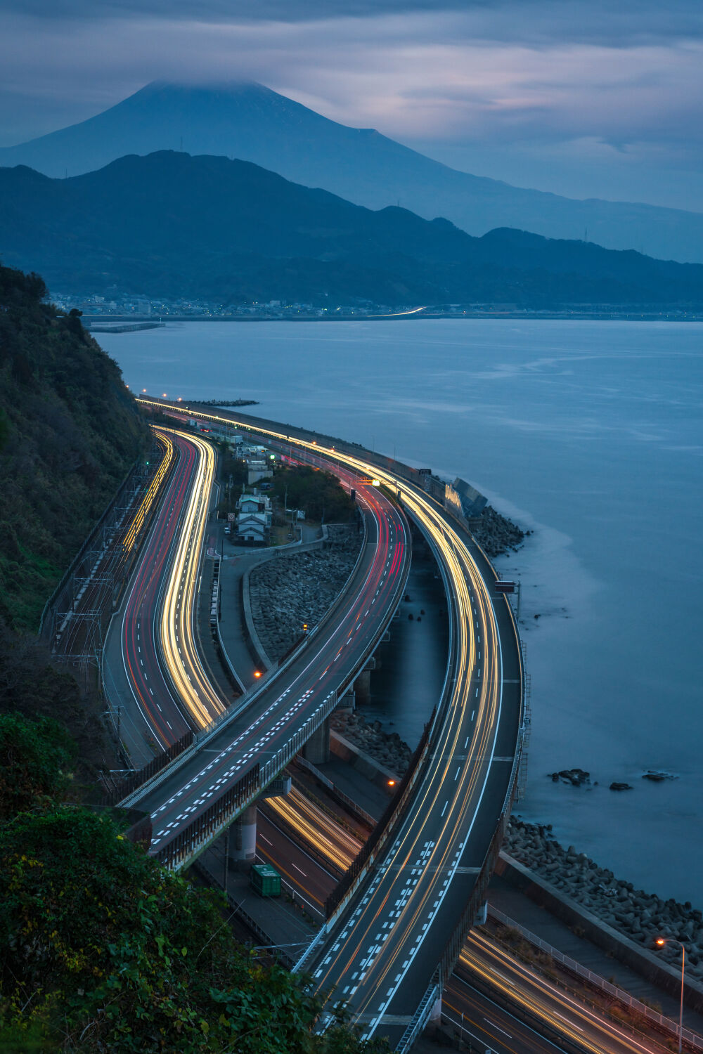 Cars and trains passing by Mt Fuji in Japan